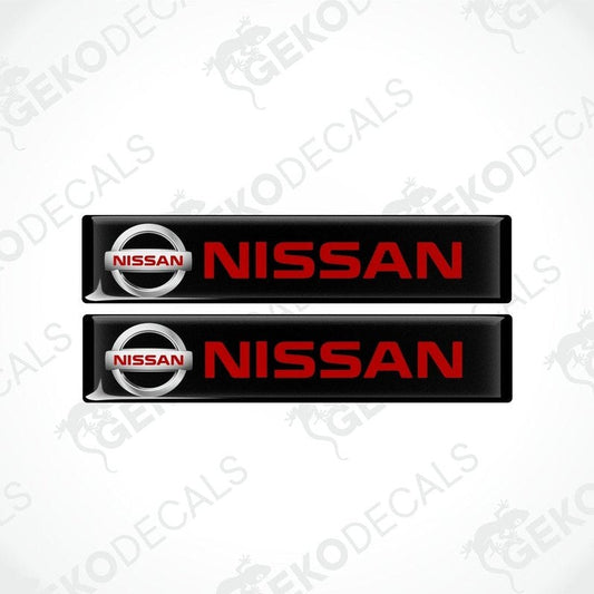 Two black vinyl stickers with the NISSAN logo in red and white.