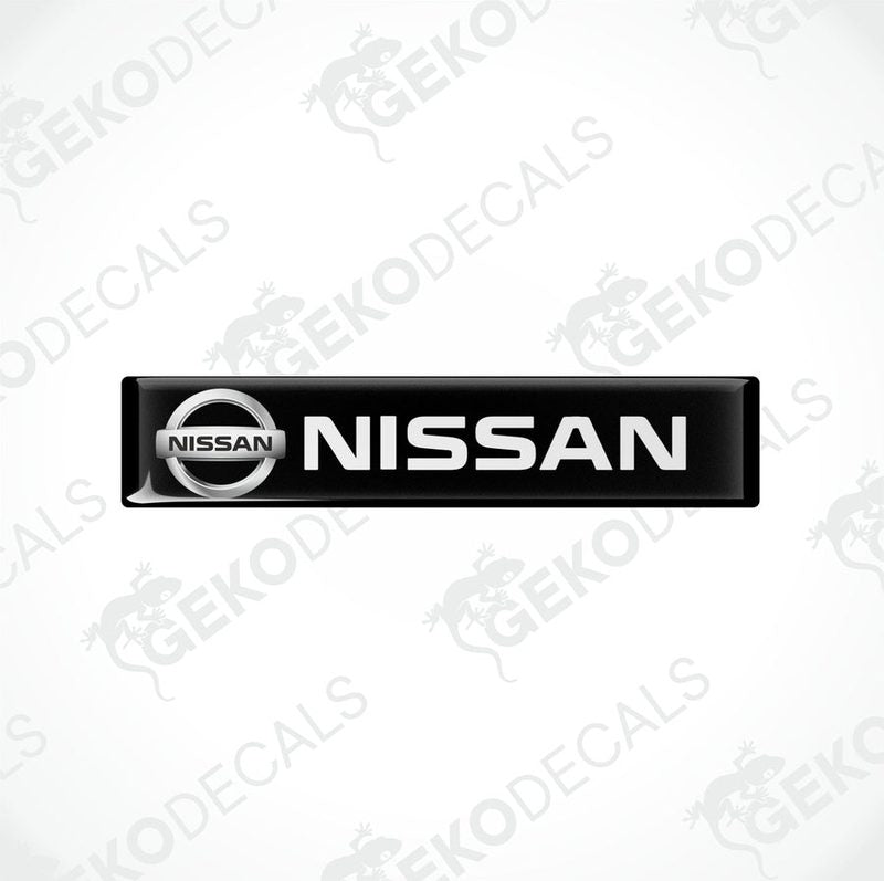Rectangular black vinyl decals with the white text 'NISSAN' on them, placed on a white background.