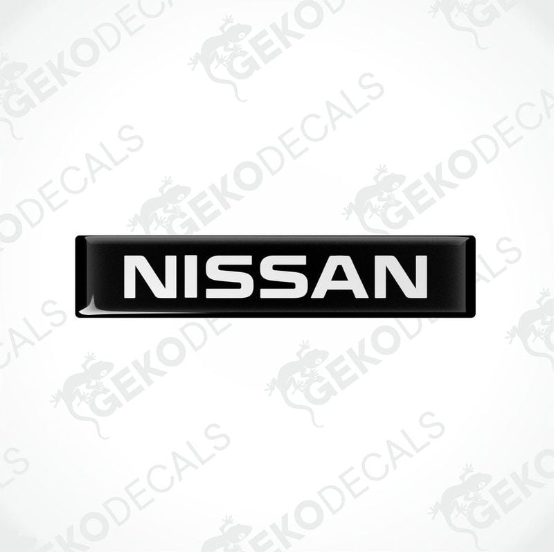 Black rectangular car decals with the text 'NISSAN' in white uppercase letters