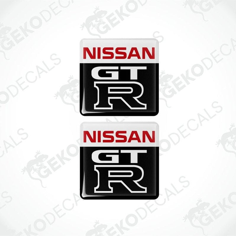 Two nissan gt r vinyl stickers with a white, red, black, and gray color scheme.