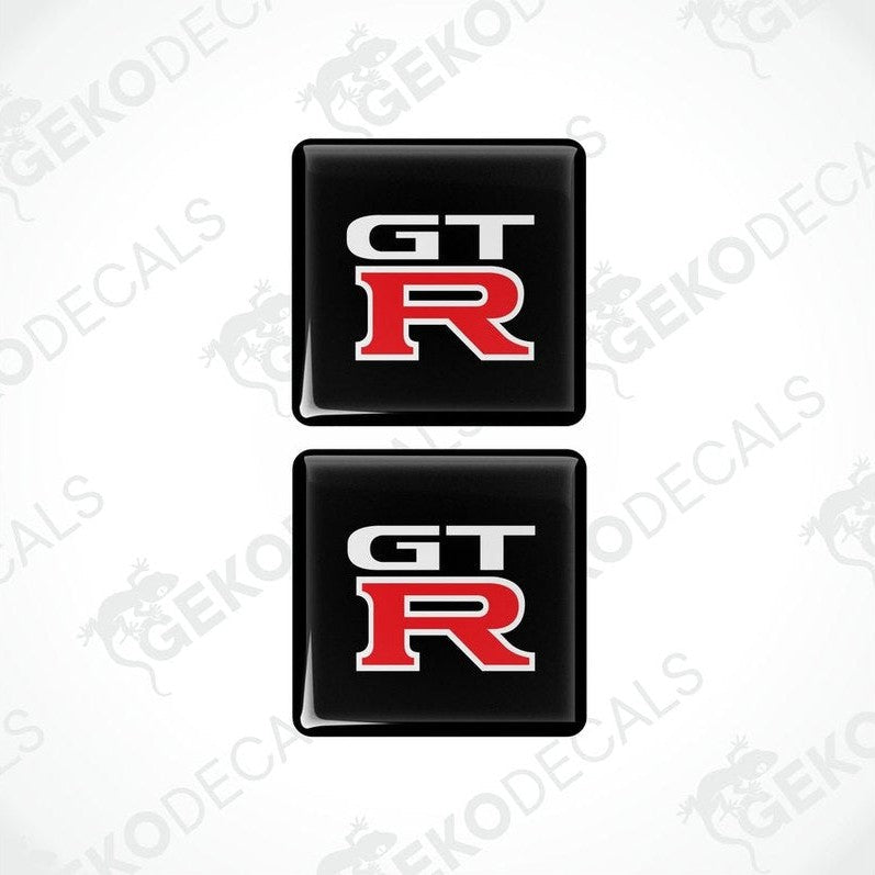 Two black vinyl stickers with the NISSAN GT R logo in red and white.