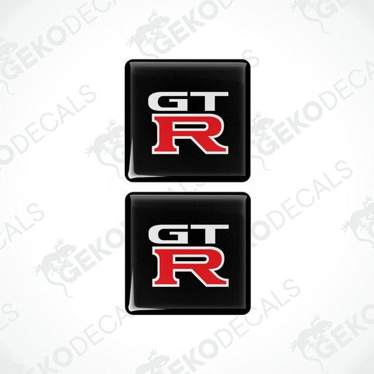 Two black vinyl stickers with the NISSAN GT R logo in red and white.
