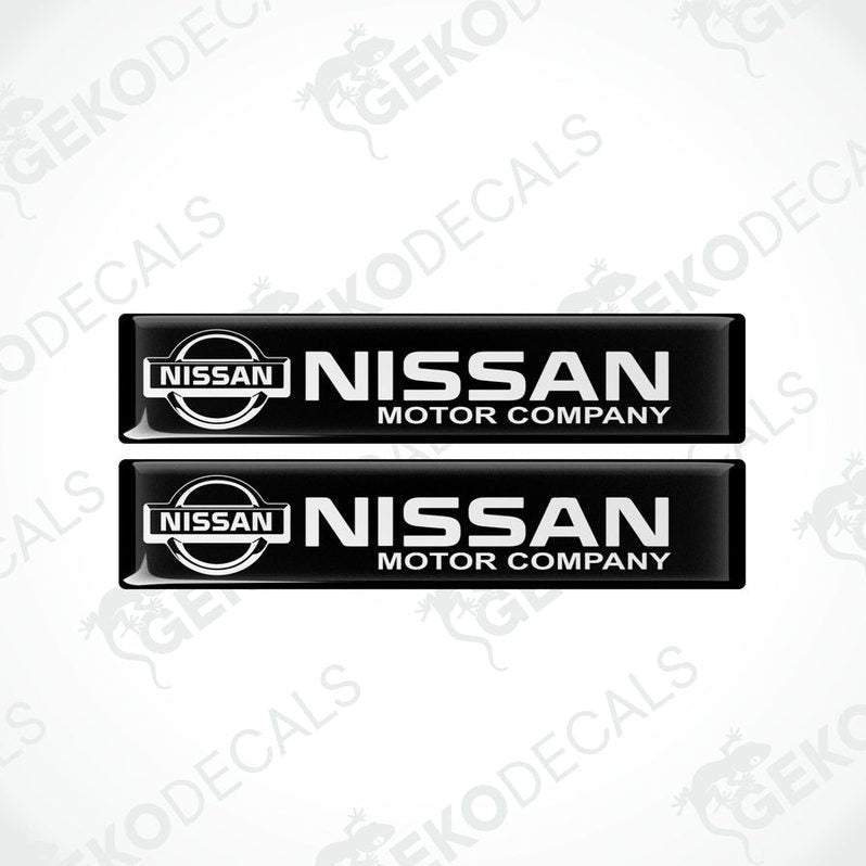 Two black vinyl stickers with the NISSAN Motor Company logo in white.
