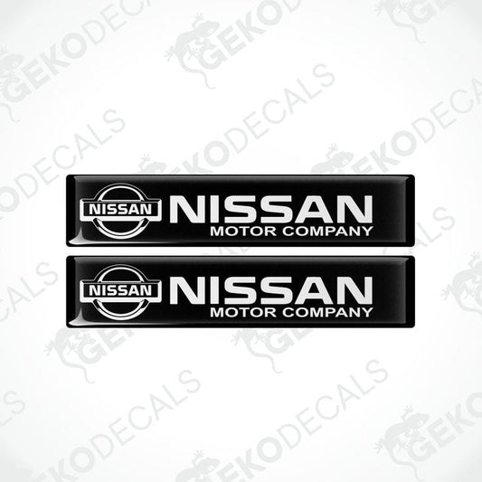 Two black vinyl stickers with the NISSAN Motor Company logo in white.