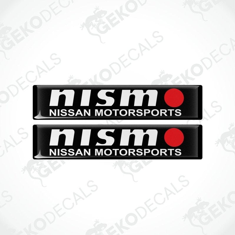 Two black vinyl stickers with white text and red accents, representing the NISSAN NISMO MOTORSPORTS logo.