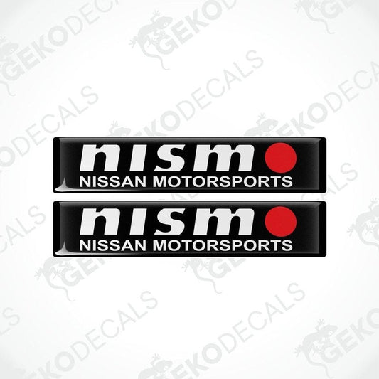 Two black vinyl stickers with white text and red accents, representing the NISSAN NISMO MOTORSPORTS logo.