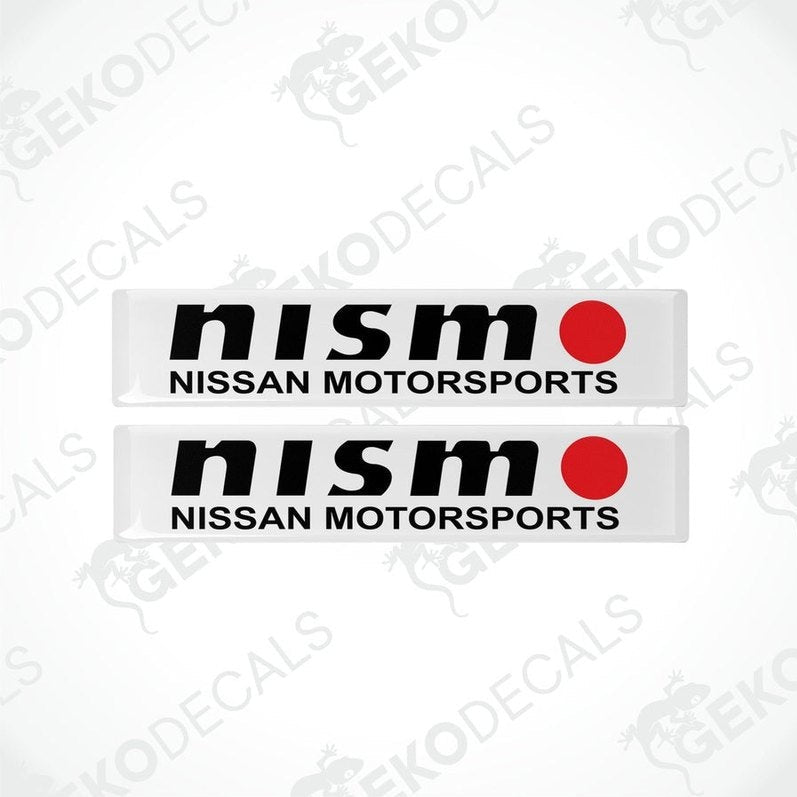 Two white vinyl stickers with black text and red accents, representing the NISSAN NISMO MOTORSPORTS logo.