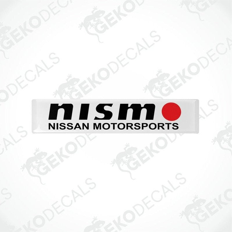 White vinyl stickers with black text and red accents, representing the NISSAN NISMO MOTORSPORTS logo.