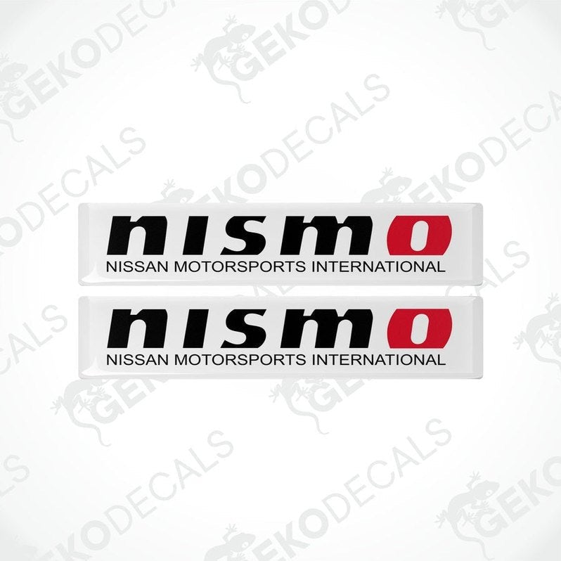 Two white, red, and black NISMO decals for vehicles.