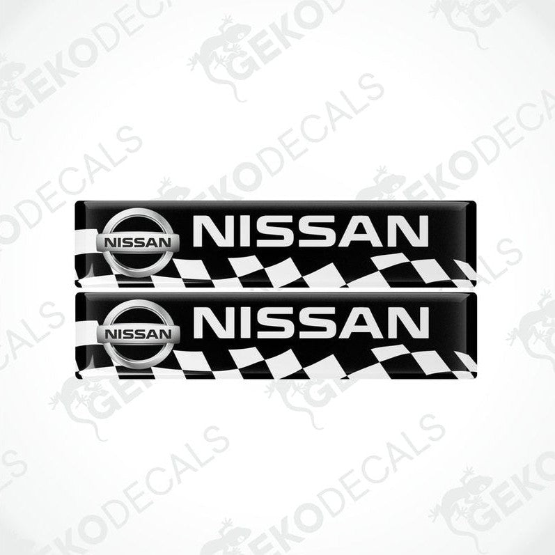 Two black and white checkered car decals with the Nissan logo