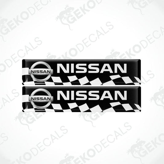 Two black and white checkered car decals with the Nissan logo