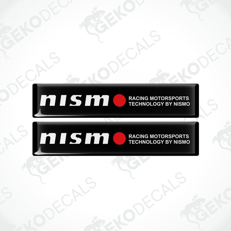 Two black vinyl stickers with red and white text, including 'NISSAN' and 'RACING MOTORSPORTS TECHNOLOGY BY NISMO'. GeckoDecals logo is visible in the corner.