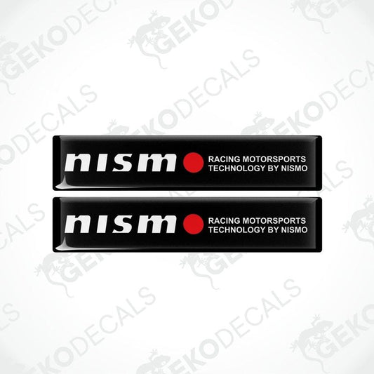 Two black vinyl stickers with red and white text, including 'NISSAN' and 'RACING MOTORSPORTS TECHNOLOGY BY NISMO'. GeckoDecals logo is visible in the corner.