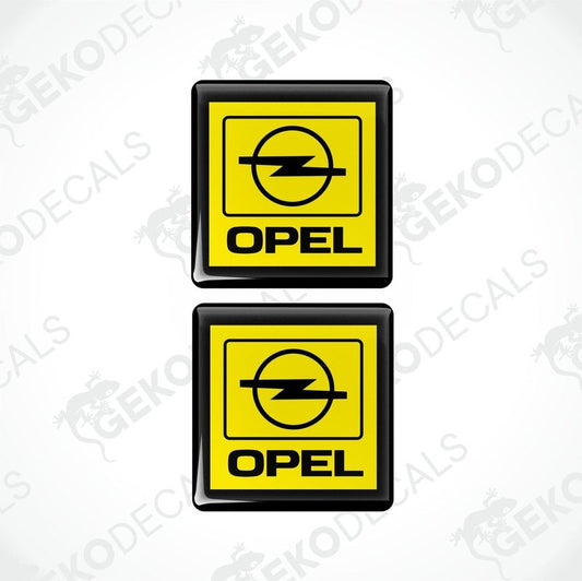 Two yellow and black vinyl stickers with a geometric design representing the Opel brand logo.