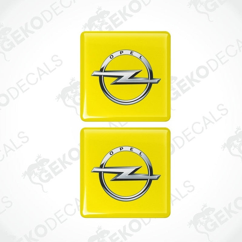 Two yellow domed stickers with the Opel logo in silver.