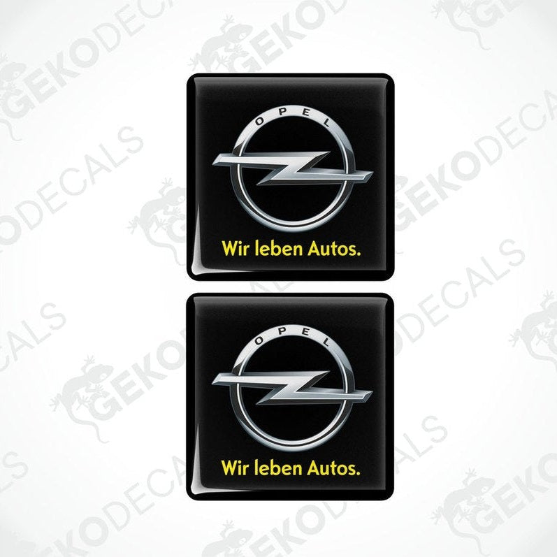 Two black vinyl stickers with the Opel brand logo and the text 'WIR LEBEN AUTOS'.