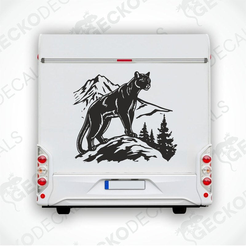 A decal of a black panther mountain scene on a white vehicle.