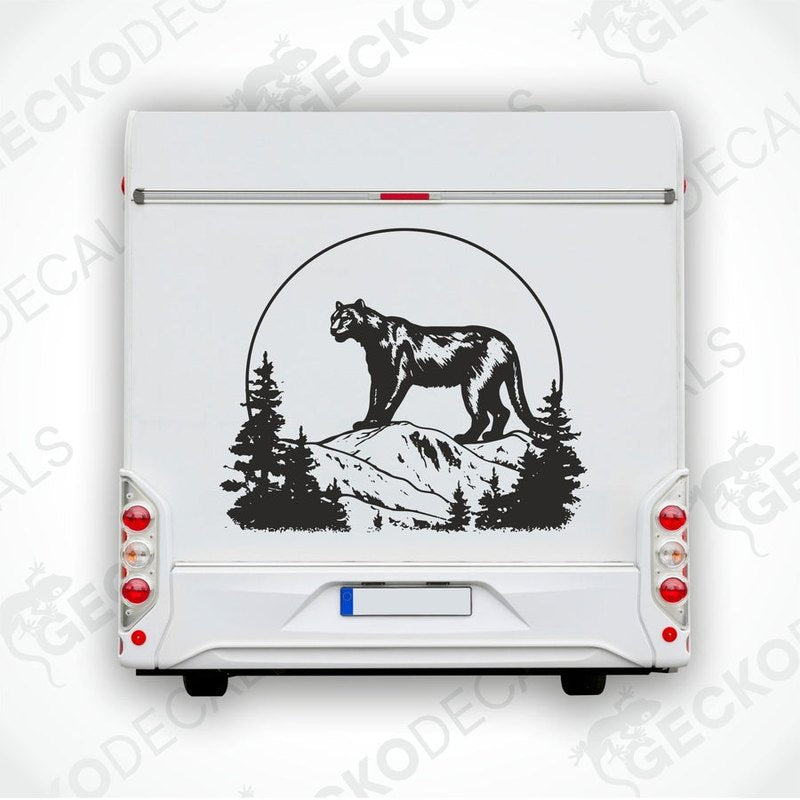 A black die cut decal of a panther in the mountains, positioned on a vehicle.