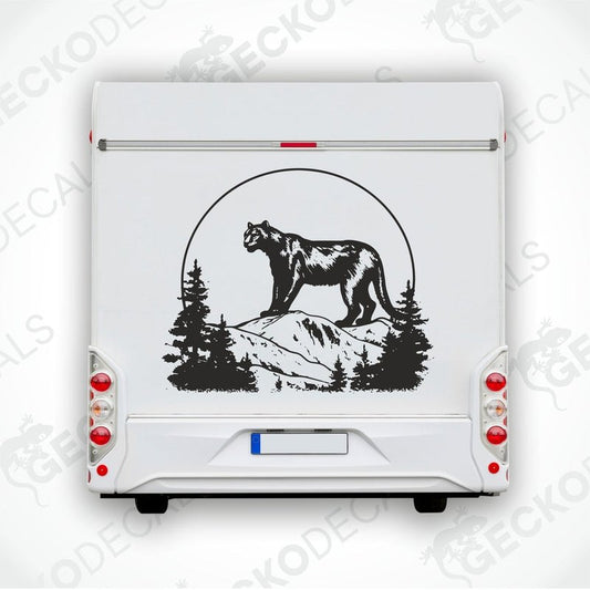 A black die cut decal of a panther in the mountains, positioned on a vehicle.