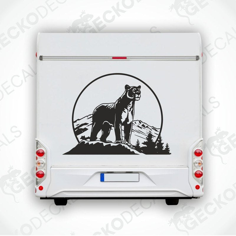 A black decal of a panther in the mountains, designed for use as a car sticker.