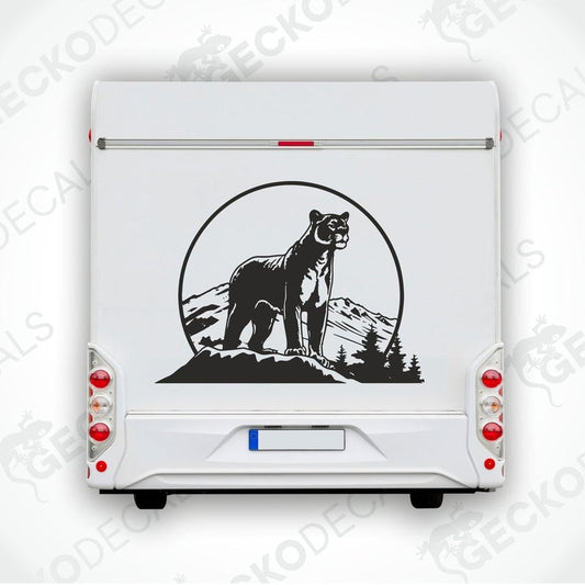 A black decal of a panther in the mountains, designed for use as a car sticker.