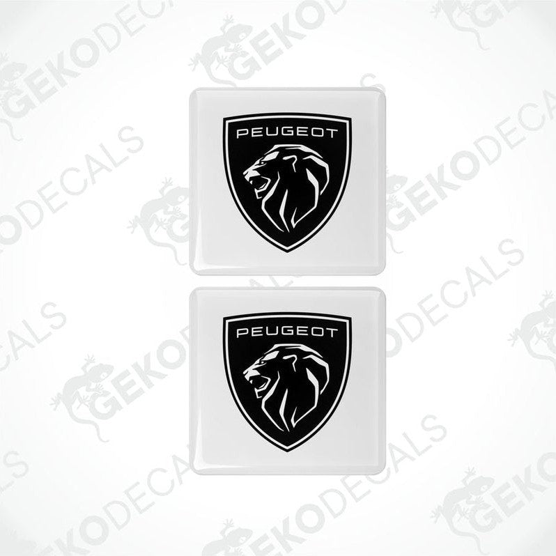 Two white vinyl stickers with a black Peugeot logo and a lion graphic.