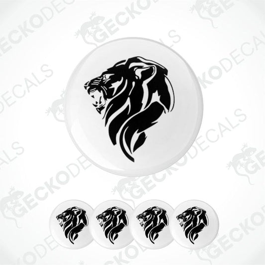 Set of five white coasters with black lion designs on a white background.