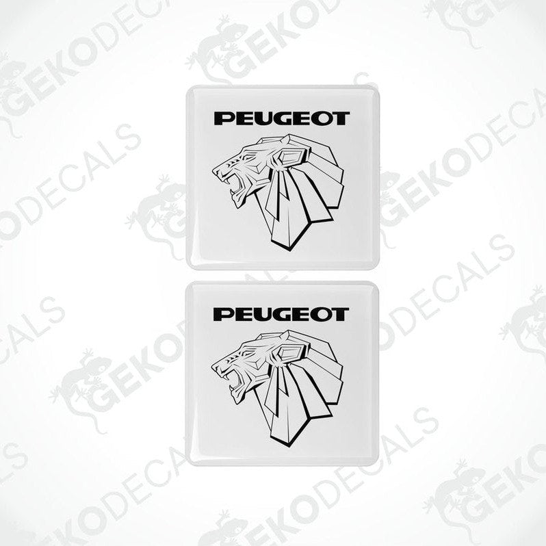 Two withe vinyl stickers with a PEUGEOT logo, placed against a black background.