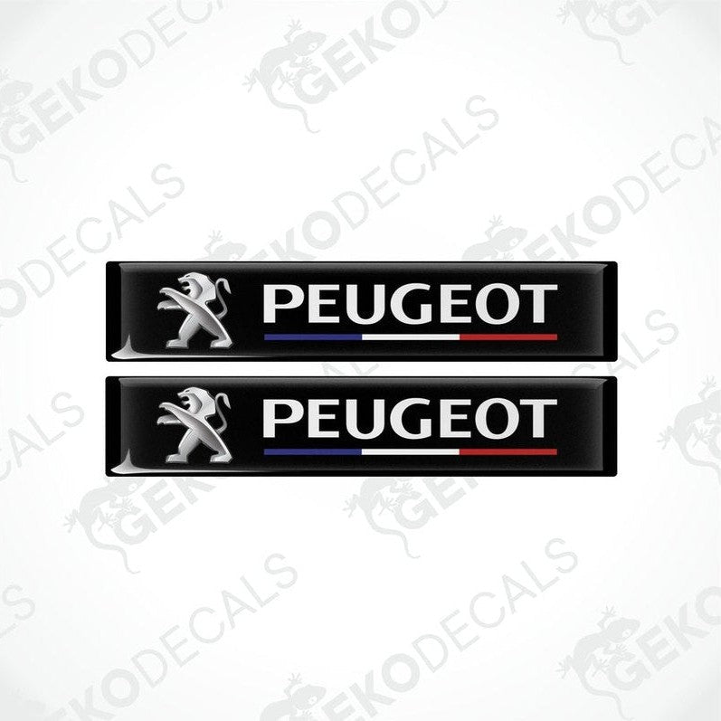 Two black vinyl decals with the PEUGEOT brand logo and the name 'FRANCE' featured in a stylized manner. The decals have a glossy finish and are designed for use as car stickers.