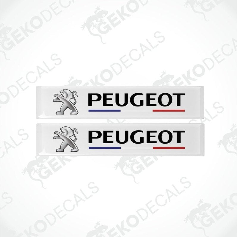 Two withe vinyl decals with the PEUGEOT brand logo and the name 'FRANCE' featured in a stylized manner. The decals have a glossy finish and are designed for use as car stickers.