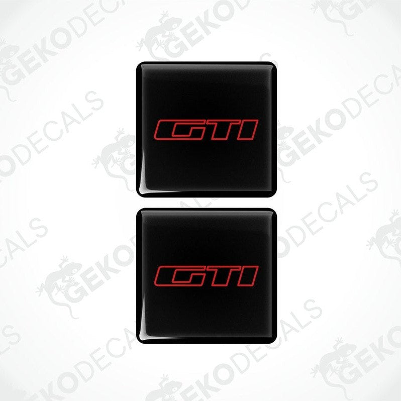 Two black vinyl stickers with the 'GTI' logo in red and white, placed on a white background.