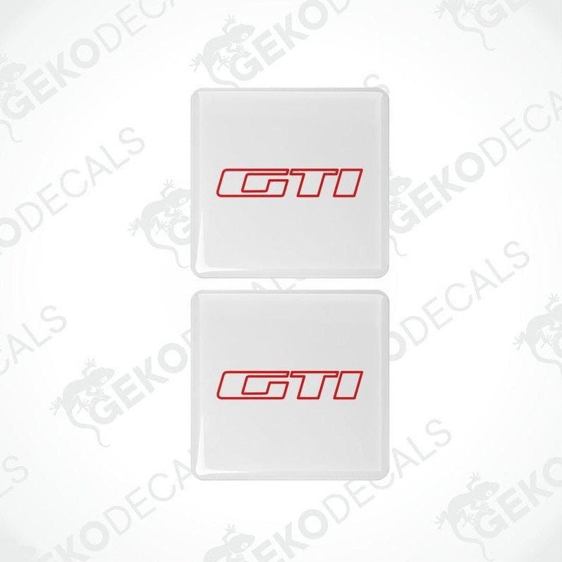 Two withe vinyl stickers with the 'GTI' logo in red and white, placed on a white background.