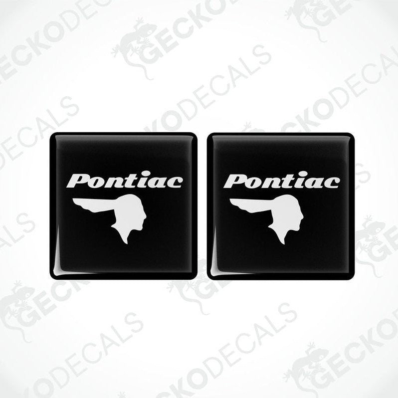 Two black vinyl stickers with a withe geometric design PONTIAC, displayed on a BLACK background.