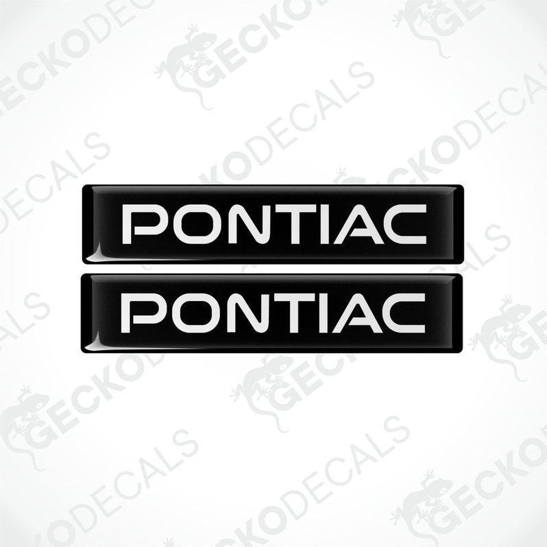 Two black and white vinyl decals with the word 'PONTIAC' printed on them.
