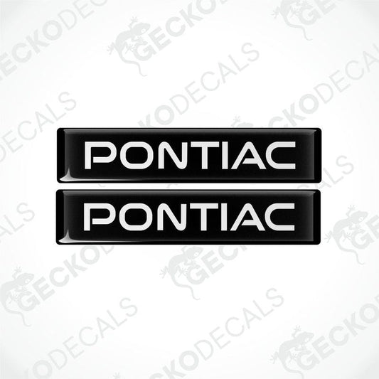 Two black and white vinyl decals with the word 'PONTIAC' printed on them.