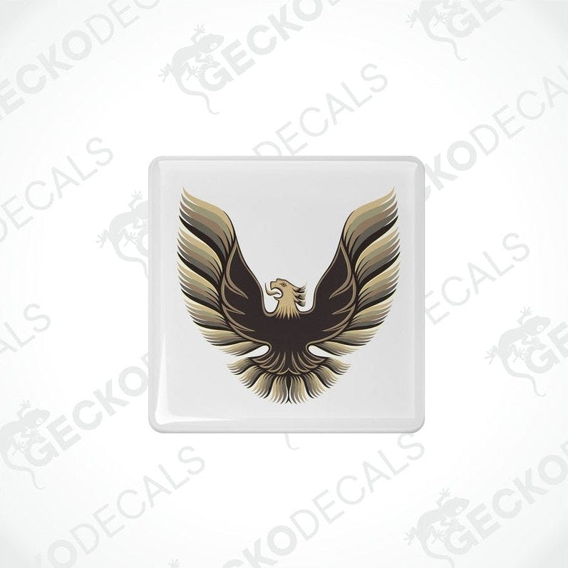 Withe vinyl stickers with a gold and bronze emblem design, placed against a white background.