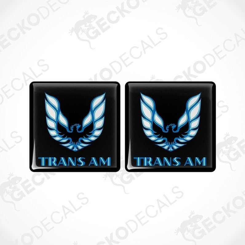 Two black vinyl stickers with a blue and white geometric design TRANS AM, displayed on a black background.