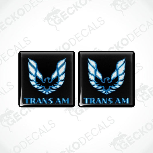 Two black vinyl stickers with a blue and white geometric design TRANS AM, displayed on a black background.