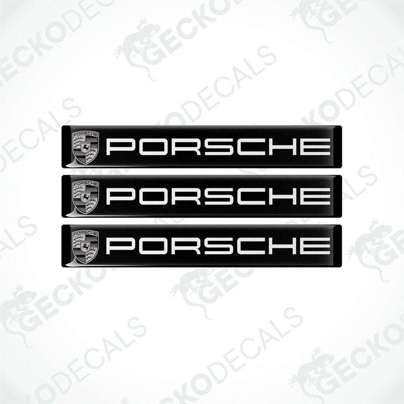 Three black vinyl stickers with the Porsche brand logo in white.