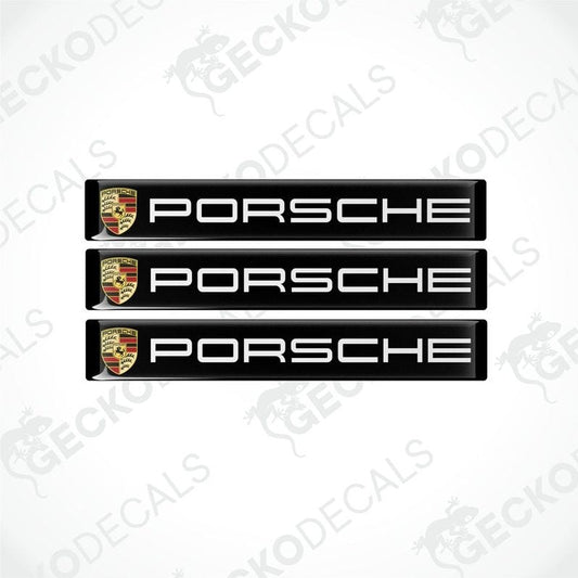 Three black vinyl stickers with the Porsche brand logo on each.