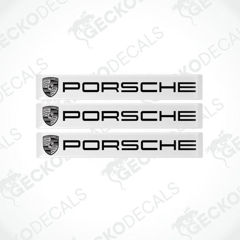 Three withe vinyl stickers with the Porsche brand logo in black.