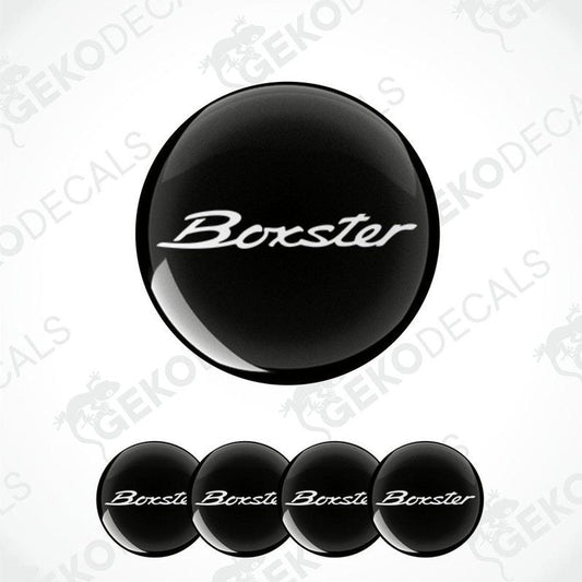 Set of four black round car decals with the text 'Boxster' on them, presented against a white background.