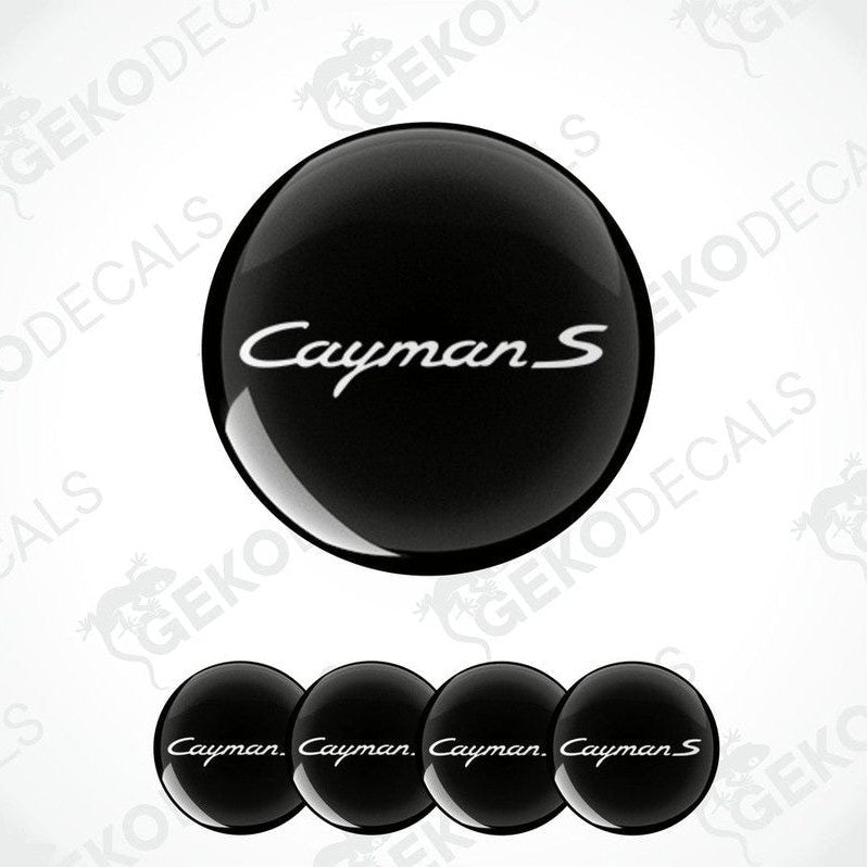 A set of four black vinyl stickers with the word 'CAYMAN S' printed on them, arranged in a stack with the top sticker being the one that shows the word 'CAYMAN S' the most clearly.