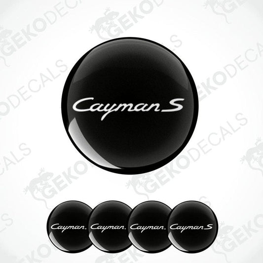A set of four black vinyl stickers with the word 'CAYMAN S' printed on them, arranged in a stack with the top sticker being the one that shows the word 'CAYMAN S' the most clearly.