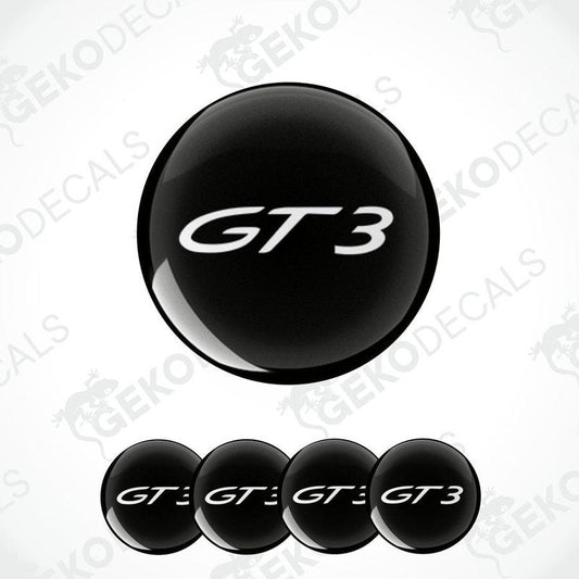 Set of four black and white vinyl decals with the GT3 logo, designed for use on car wheel caps.