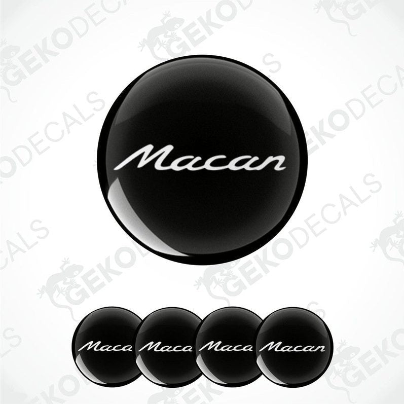 A set of four black vinyl stickers with the word 'MACAN' written on them, arranged in a dome shape with a visible brand logo in the center.