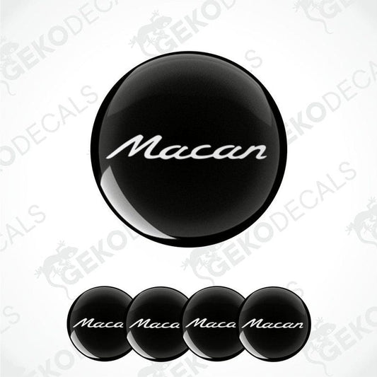 A set of four black vinyl stickers with the word 'MACAN' written on them, arranged in a dome shape with a visible brand logo in the center.