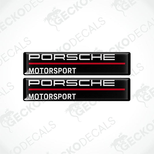 Two rectangular black vinyl decals with 'PORSCHE MOTORSPORT' text in white and red.