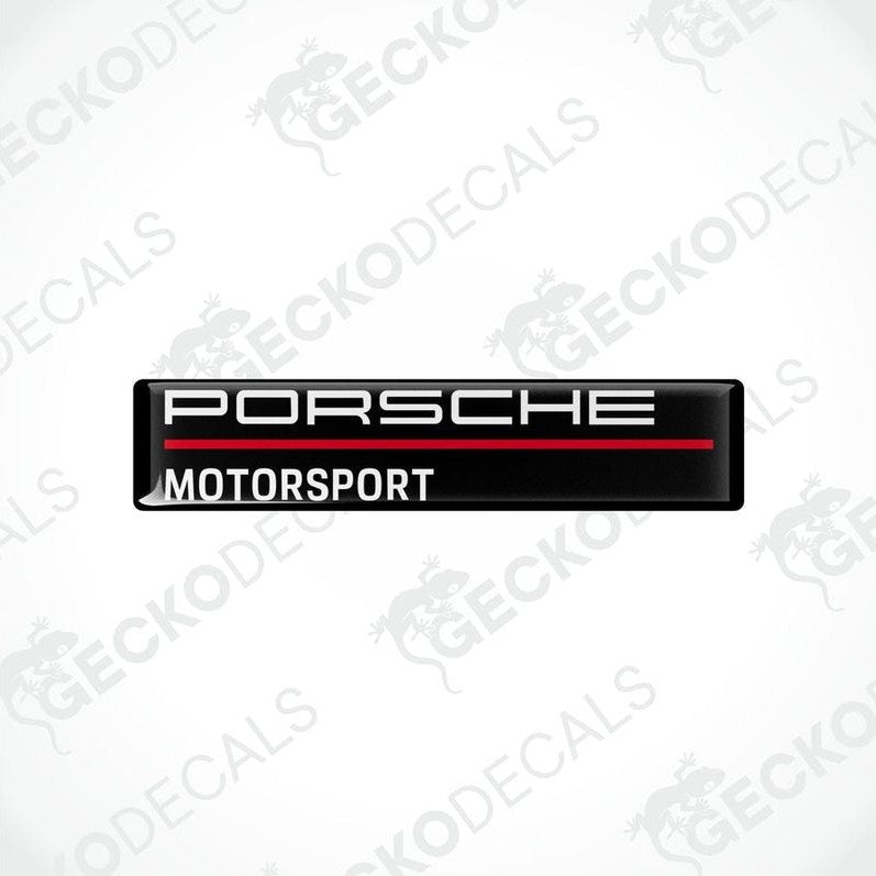Rectangular black vinyl decals with 'PORSCHE MOTORSPORT' text in white and red.