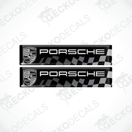 Two black vinyl stickers with the Porsche racing logo and a checkered pattern.